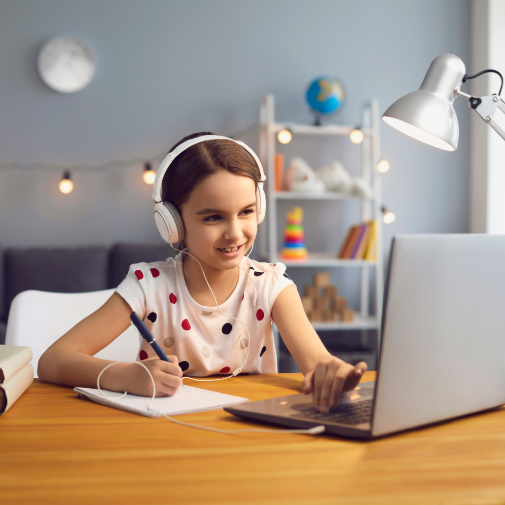 young girl doing school work on computer
