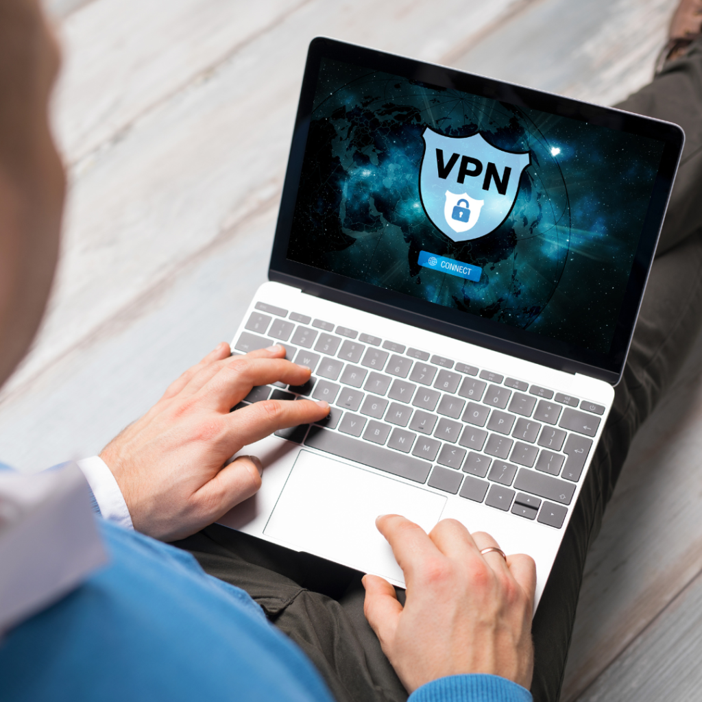 man on a laptop with a VPN symbol on the laptop