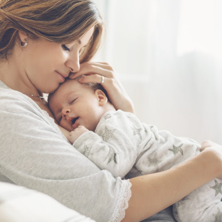 mother holding a sleeping baby