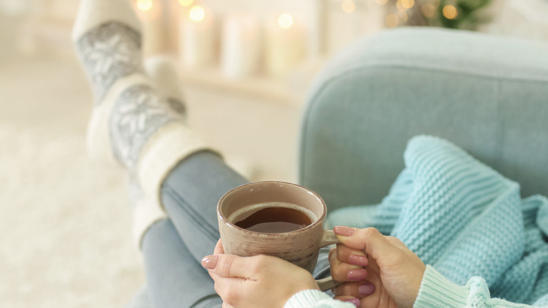 Woman relaxing of sofa with cup of coffee