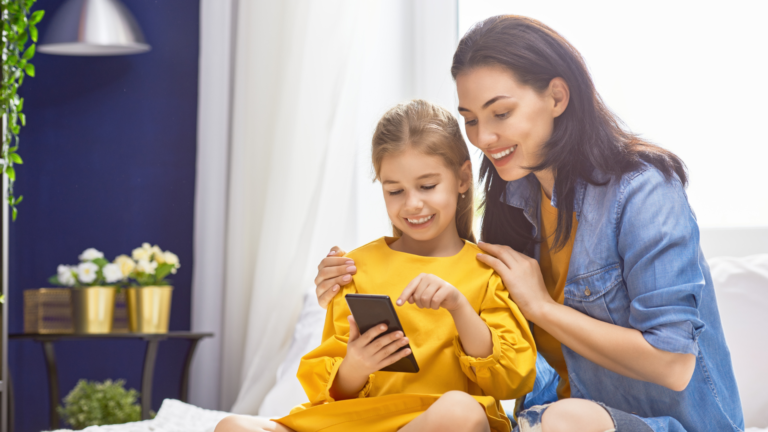 mother and daughter looking at a mobile phone