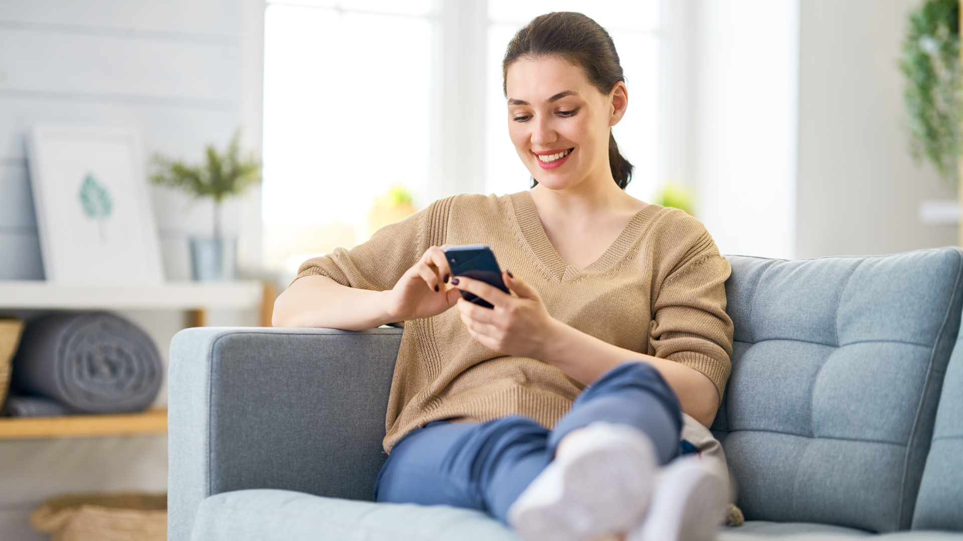 Woman on sofa on her phone